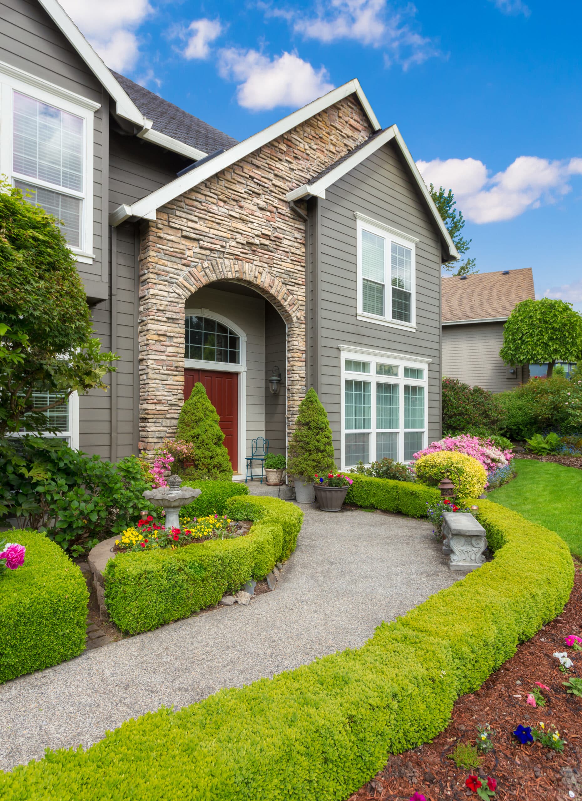 Beautiful New Home Exterior and Landscaping on Sunny Afternoon