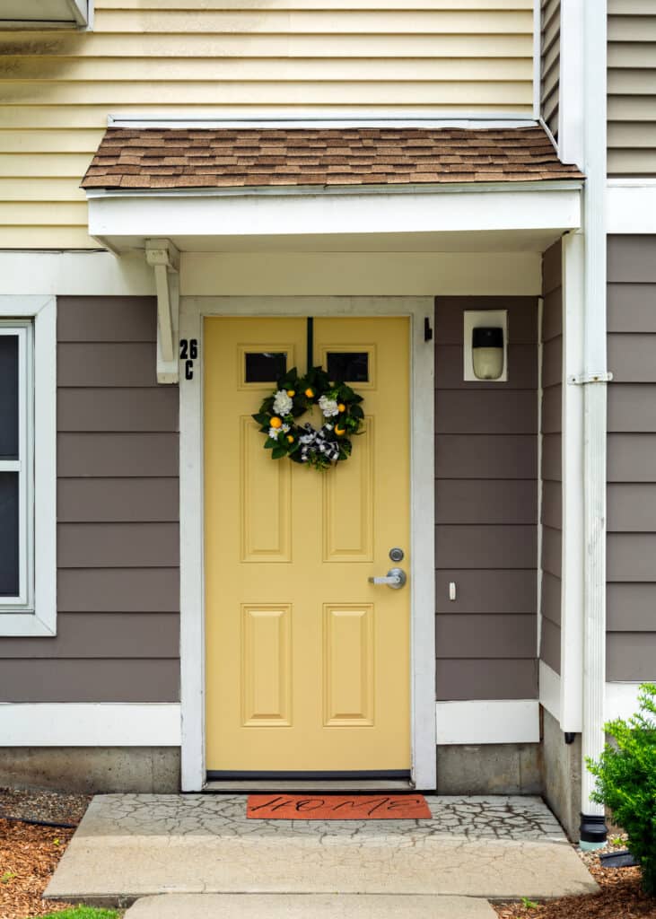 front entrance door and vinyl siding